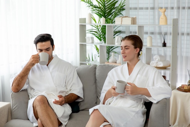 couple wearing bathrobe relaxing with drinks luxurious hotel spa quiescent 31965 344854